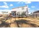 Fenced backyard featuring a trampoline, playset, and covered porch at 106 Capanne Ct, Clayton, NC 27527