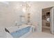 Luxurious bathroom with soaking tub, separate shower, and access to walk-in closet at 106 Capanne Ct, Clayton, NC 27527