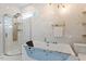 Modern bathroom featuring soaking tub with jets, separate shower, and elegant gold fixtures at 106 Capanne Ct, Clayton, NC 27527