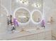 Modern main bathroom with double sinks, illuminated mirrors, and stylish accents at 106 Capanne Ct, Clayton, NC 27527