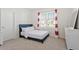 Cozy bedroom features a plush bed, neutral carpet, and bright window at 106 Capanne Ct, Clayton, NC 27527