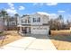 Inviting two-story home with a two-car garage and a well-manicured front lawn at 106 Capanne Ct, Clayton, NC 27527