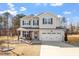 Charming two-story home with gray siding, black shutters, and a welcoming front porch at 106 Capanne Ct, Clayton, NC 27527