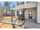 Cozy front porch with seating area and stylish landscaping at 106 Capanne Ct, Clayton, NC 27527