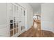 Bright hallway with hardwood floors and French doors leading to another room at 106 Capanne Ct, Clayton, NC 27527