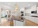 Well-designed kitchen with a large island, granite countertops, and stainless steel appliances at 106 Capanne Ct, Clayton, NC 27527