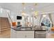 Open kitchen with an island, granite countertops, stainless steel appliances, and seamless access to living areas at 106 Capanne Ct, Clayton, NC 27527