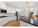 Beautiful kitchen featuring granite countertops, stainless steel appliances, white cabinetry, and bright lighting at 106 Capanne Ct, Clayton, NC 27527