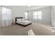 Spacious main bedroom with plush carpet, natural light, and neutral decor at 106 Capanne Ct, Clayton, NC 27527