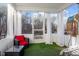 Enclosed sunroom with turf, sheer curtains, and comfortable seating at 106 Capanne Ct, Clayton, NC 27527