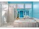 A modern bathroom with separate shower and soaking tub with tile surround and blue walls at 108 Finnway Ln, Cary, NC 27519