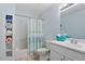 This bathroom features a tub with shower, tile floor, modern vanity, and linen closet at 108 Finnway Ln, Cary, NC 27519