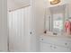 A light bathroom featuring white vanity cabinets and a shower with white curtain at 108 Finnway Ln, Cary, NC 27519