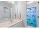 This bathroom features a large mirror, white vanity, dolphin shower curtain, and light blue walls at 108 Finnway Ln, Cary, NC 27519