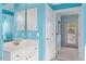 A powder blue bathroom featuring a stylish vanity and access to a hallway at 108 Finnway Ln, Cary, NC 27519
