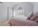 A light-filled bedroom with pink bedding and large windows at 108 Finnway Ln, Cary, NC 27519