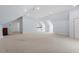 Spacious bonus room featuring vaulted ceilings, ample natural light, and neutral carpeting at 108 Finnway Ln, Cary, NC 27519