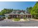 View of community clubhouse with well-maintained landscaping and parking area at 108 Finnway Ln, Cary, NC 27519