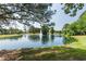Enjoy the community pond with fountain feature, park bench, and grassy shoreline at 108 Finnway Ln, Cary, NC 27519