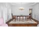 Formal dining room featuring hardwood floors, an elegant chandelier, and traditional furnishings at 108 Finnway Ln, Cary, NC 27519