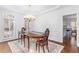 Formal dining room featuring hardwood floors, an elegant chandelier, and traditional furnishings at 108 Finnway Ln, Cary, NC 27519