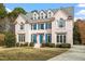 Charming two-story home with a brick facade, blue shutters, and a well-maintained front yard at 108 Finnway Ln, Cary, NC 27519