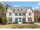 Charming two-story home with a brick facade, blue shutters, and a well-maintained front yard at 108 Finnway Ln, Cary, NC 27519