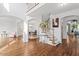 Elegant foyer with hardwood floors, staircase, chandelier, and views into other living spaces at 108 Finnway Ln, Cary, NC 27519