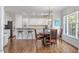 Bright eat-in kitchen features white cabinets, stainless appliances, and granite countertops at 108 Finnway Ln, Cary, NC 27519