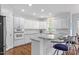 Modern kitchen with white cabinets, granite countertops, stainless steel appliances, and hardwood floors at 108 Finnway Ln, Cary, NC 27519