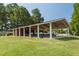 Community picnic shelter with tables, adjacent to level, grassy yard surrounded by mature trees at 108 Finnway Ln, Cary, NC 27519