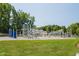 Well-equipped community playground for neighborhood children, set in a grassy yard and surrounded by trees at 108 Finnway Ln, Cary, NC 27519