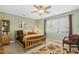 Cozy bedroom with carpet flooring, ceiling fan and a large window at 1109 Frenchurch Way, Apex, NC 27502