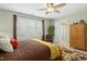 Comfortable bedroom with ceiling fan, closet, and natural light. Bathroom is ensuite at 1109 Frenchurch Way, Apex, NC 27502