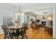 Sunlit breakfast nook with hardwood floors and a view into the comfortable living room at 1109 Frenchurch Way, Apex, NC 27502