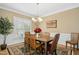 Elegant dining room with a chandelier, decorative rug, and ample seating at 1109 Frenchurch Way, Apex, NC 27502