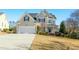 Charming two-story home with a well-manicured lawn and attached two-car garage at 1109 Frenchurch Way, Apex, NC 27502
