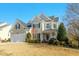 Charming two-story home with a well-manicured lawn and attached two-car garage at 1109 Frenchurch Way, Apex, NC 27502