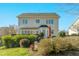 Rear exterior of the home with a well-manicured yard, deck, and attractive landscaping at 1109 Frenchurch Way, Apex, NC 27502