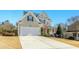 Charming two-story home with a well-manicured lawn and attached two-car garage at 1109 Frenchurch Way, Apex, NC 27502