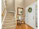 Welcoming foyer with hardwood floors, staircase, and decorative mirror at 1109 Frenchurch Way, Apex, NC 27502