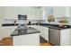 Modern kitchen with stainless steel appliances, granite countertops, and white cabinetry at 1109 Frenchurch Way, Apex, NC 27502