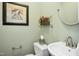 Charming powder room featuring a pedestal sink and decorative accents at 1109 Frenchurch Way, Apex, NC 27502