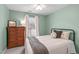 Inviting bedroom with green walls features a full-sized bed and wooden dresser at 11228 N Radner Way, Raleigh, NC 27613