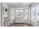Bright breakfast nook with large windows and a charming cabinet and serving area at 11228 N Radner Way, Raleigh, NC 27613