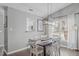 Inviting dining room with modern light fixture and ample natural light at 11228 N Radner Way, Raleigh, NC 27613