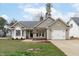Charming one-story home featuring a well-maintained front yard and a convenient attached garage at 11228 N Radner Way, Raleigh, NC 27613
