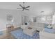 Open living space with blue rug and large sectional sofa at 11228 N Radner Way, Raleigh, NC 27613