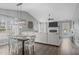 Open concept living room with hardwood floors, dining area, and fireplace at 11228 N Radner Way, Raleigh, NC 27613