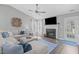 Bright living room with fireplace, grey sofa, and open space at 11228 N Radner Way, Raleigh, NC 27613